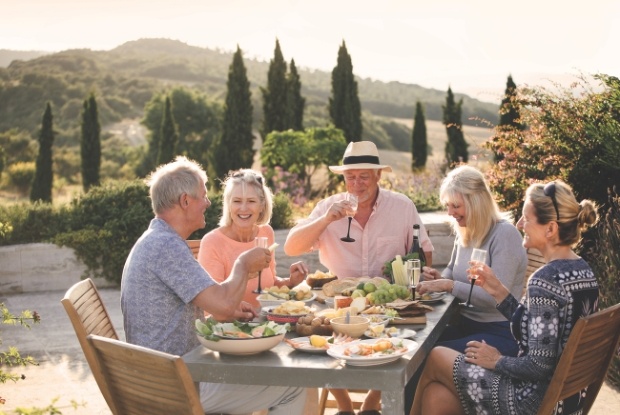 Mature aged group dining together